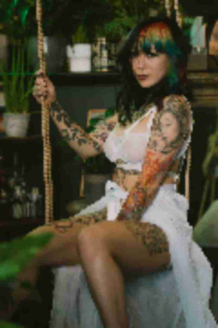 Kosmic Kitty, posing for a photo taken by Sinner Vision