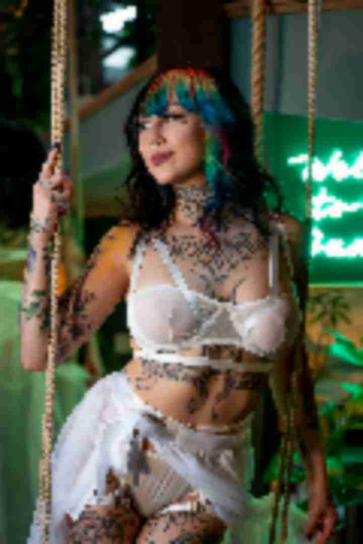 Kosmic Kitty, posing for a photo taken by Sinner Vision